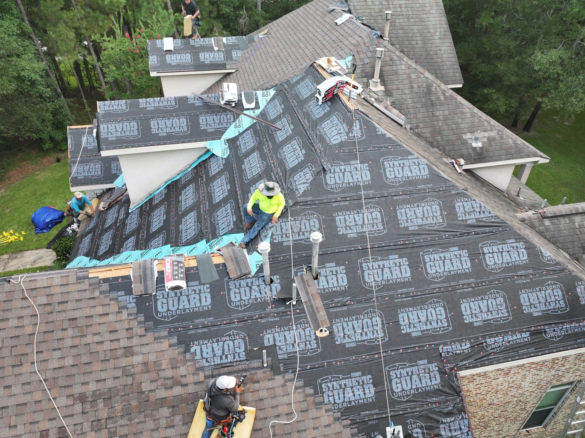 Roof replacement in progress with new underlayment